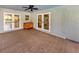 Covered patio with ample space, a ceiling fan, and a view of the screened-in pool area at 245 Woodingham Trl, Venice, FL 34292