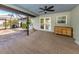 Spacious screened-in patio with doors leading to the pool area and a serene backyard view at 245 Woodingham Trl, Venice, FL 34292