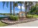 Community sign for Chestnut Creek surrounded by lush landscaping and trees at 245 Woodingham Trl, Venice, FL 34292