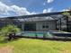 A backyard with a screened-in pool, spa, and covered patio at 25240 Keygrass Ct, Punta Gorda, FL 33955