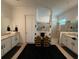 Modern bathroom with dual vanities, framed mirrors, and glass-enclosed shower at 25240 Keygrass Ct, Punta Gorda, FL 33955