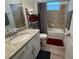 Cozy bathroom features vanity, bathtub, toilet and tiled walls at 25240 Keygrass Ct, Punta Gorda, FL 33955