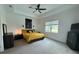 Spacious bedroom with tray ceiling, large window, and neutral color palette at 25240 Keygrass Ct, Punta Gorda, FL 33955