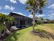 An exterior view of the screened-in pool and patio of a gray home at 25240 Keygrass Ct, Punta Gorda, FL 33955
