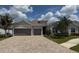 Charming single-story home with a paved driveway and a two-car garage at 25240 Keygrass Ct, Punta Gorda, FL 33955