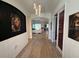 Elegant foyer with artistic decor, leading to open living spaces with tile flooring at 25240 Keygrass Ct, Punta Gorda, FL 33955