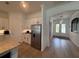 Well-lit kitchen featuring granite counters, stainless appliances, and seamless flow into the foyer at 25240 Keygrass Ct, Punta Gorda, FL 33955
