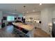 Contemporary kitchen with barstool seating at the island and a view into the living area at 25240 Keygrass Ct, Punta Gorda, FL 33955