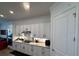 Efficient kitchen design with white cabinetry, granite counters, and stainless steel appliances at 25240 Keygrass Ct, Punta Gorda, FL 33955