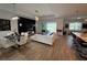 Bright living room featuring hardwood floors, modern furnishings, and backyard access at 25240 Keygrass Ct, Punta Gorda, FL 33955