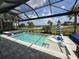 A screened-in pool boasts a lovely view of the adjacent golf course at 25240 Keygrass Ct, Punta Gorda, FL 33955