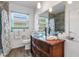 Bathroom with a modern glass bowl sink, wood-style flooring and ample light at 3026 New England St, Sarasota, FL 34231