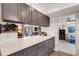 Galley-style kitchen with gray cabinets, stainless steel appliances, and white countertops at 3026 New England St, Sarasota, FL 34231