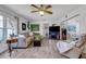 Comfortable living room with a large sectional sofa, ceiling fan, and wood-look flooring at 3026 New England St, Sarasota, FL 34231