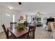 Open concept living and dining area featuring wood floors and a light-filled atmosphere at 3026 New England St, Sarasota, FL 34231