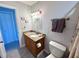 Bright bathroom with granite counter, a decorative mirror and modern lighting fixture at 3447 Clark Rd # 246, Sarasota, FL 34231