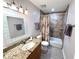 Bathroom features a granite-topped vanity and a tiled shower-tub combination at 3447 Clark Rd # 246, Sarasota, FL 34231