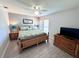 Cozy bedroom featuring a wood-frame bed, ceiling fan, and matching dressers, perfect for relaxing at 3447 Clark Rd # 246, Sarasota, FL 34231
