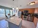 Kitchen and dining area featuring stainless-steel appliances, granite countertops, and decorative pendant lighting at 3447 Clark Rd # 246, Sarasota, FL 34231