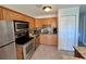 Modern kitchen featuring stainless steel appliances, granite countertops, and ample cabinet space at 3447 Clark Rd # 246, Sarasota, FL 34231
