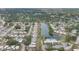 Enjoy this picturesque aerial view of a residential community with lush greenery, a sparkling lake, and a refreshing community pool at 3941 Glen Oaks E Dr # 32, Sarasota, FL 34232