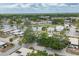 Scenic aerial view of a well-maintained community with mature trees, a pond, and a pool at 3941 Glen Oaks E Dr # 32, Sarasota, FL 34232