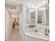Well-lit bathroom with a spacious vanity and decorative mirrors at 3941 Glen Oaks E Dr # 32, Sarasota, FL 34232
