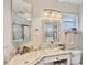 Well-lit bathroom features tiled vanity, granite countertop, and glass enclosed shower at 3941 Glen Oaks E Dr # 32, Sarasota, FL 34232