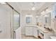 Well-lit bathroom features tiled vanity, corner countertop, and glass enclosed shower at 3941 Glen Oaks E Dr # 32, Sarasota, FL 34232