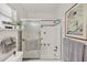 Clean bathroom with shower and tub featuring neutral tile, plus decorative art and plants at 3941 Glen Oaks E Dr # 32, Sarasota, FL 34232