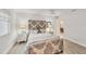 Well-lit bedroom boasts modern wood floors, patterned headboard, and ample natural light at 3941 Glen Oaks E Dr # 32, Sarasota, FL 34232