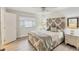 Bright bedroom featuring a plush bed, wood floors, and a ceiling fan at 3941 Glen Oaks E Dr # 32, Sarasota, FL 34232