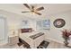 Cozy bedroom with wood-look floors, neutral walls, and a ceiling fan at 3941 Glen Oaks E Dr # 32, Sarasota, FL 34232