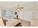Bright bedroom with a large window, wood-look floors, and a ceiling fan at 3941 Glen Oaks E Dr # 32, Sarasota, FL 34232