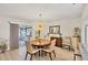 Well-lit dining area featuring wood floors, slider door access, modern light fixture and dining table at 3941 Glen Oaks E Dr # 32, Sarasota, FL 34232