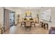 Open-concept dining area with natural light, modern chandelier, and seamless flow to the adjacent kitchen at 3941 Glen Oaks E Dr # 32, Sarasota, FL 34232