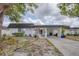 Charming single-story home with a covered carport and a welcoming front entrance, complemented by beautiful landscaping at 3941 Glen Oaks E Dr # 32, Sarasota, FL 34232