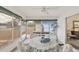 Bright Florida room with table, chairs, and large windows offers a relaxing view of the lush outdoor landscape at 3941 Glen Oaks E Dr # 32, Sarasota, FL 34232