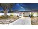 Charming single-story home featuring a covered carport and a welcoming front patio with decorative plants and an American flag at 3941 Glen Oaks E Dr # 32, Sarasota, FL 34232