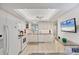 Bright kitchen with white cabinets, tile floors, granite countertops and modern appliances at 3941 Glen Oaks E Dr # 32, Sarasota, FL 34232
