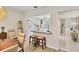 Bright kitchen with granite countertops, white cabinets, and bar seating adjacent to a light-filled dining area at 3941 Glen Oaks E Dr # 32, Sarasota, FL 34232