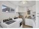 Well-equipped laundry room with modern washer and dryer, plus ample storage cabinets at 3941 Glen Oaks E Dr # 32, Sarasota, FL 34232