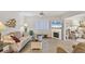 Bright living room featuring modern flooring, a fireplace, and comfortable seating for relaxation and entertainment at 3941 Glen Oaks E Dr # 32, Sarasota, FL 34232