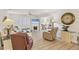 Open-concept living room featuring fireplace and seamless flow to other rooms at 3941 Glen Oaks E Dr # 32, Sarasota, FL 34232