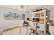 Bright home office with a window overlooking the property, with a desk, ceiling fan, and built-in storage at 3941 Glen Oaks E Dr # 32, Sarasota, FL 34232
