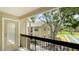 View from the balcony shows tropical landscaping, mature trees and lawn at 4009 Crockers Lake Blvd # 22, Sarasota, FL 34238