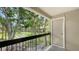 View from the balcony shows a shuffleboard court and plenty of trees at 4009 Crockers Lake Blvd # 22, Sarasota, FL 34238