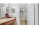 Bright bathroom with a walk-in closet and updated vanity with a neutral countertop at 4009 Crockers Lake Blvd # 22, Sarasota, FL 34238