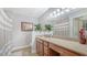 Bathroom showcasing a long countertop with plants and striped shower curtain at 4009 Crockers Lake Blvd # 22, Sarasota, FL 34238