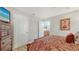 A peek into the ensuite bathroom from the primary bedroom with wood-look floors at 4009 Crockers Lake Blvd # 22, Sarasota, FL 34238